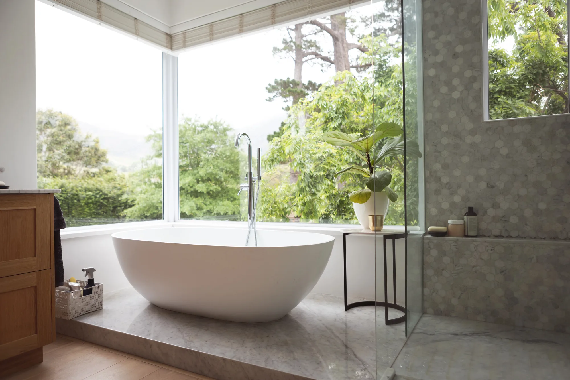 Renovated bathroom with floor to ceiling windows and a freestanding tub