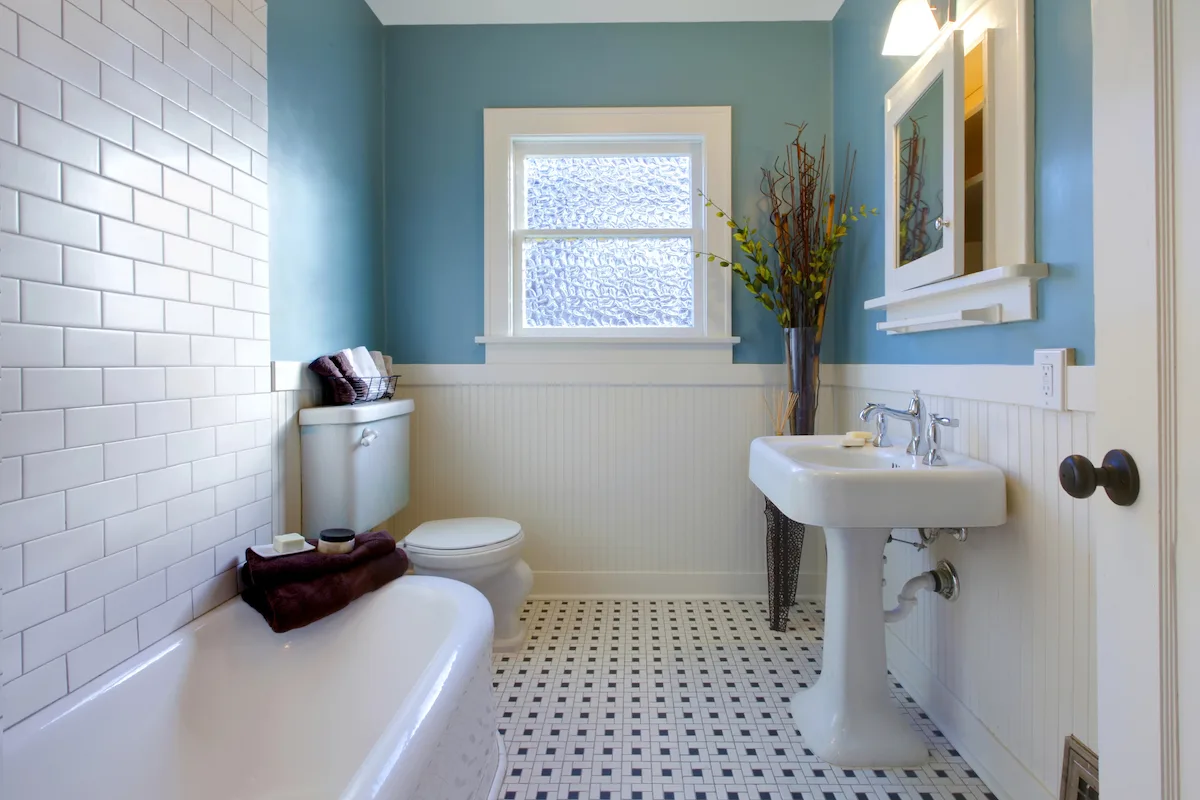 Renovated brick veneer home bathroom with clawfoot bath and subway tiles