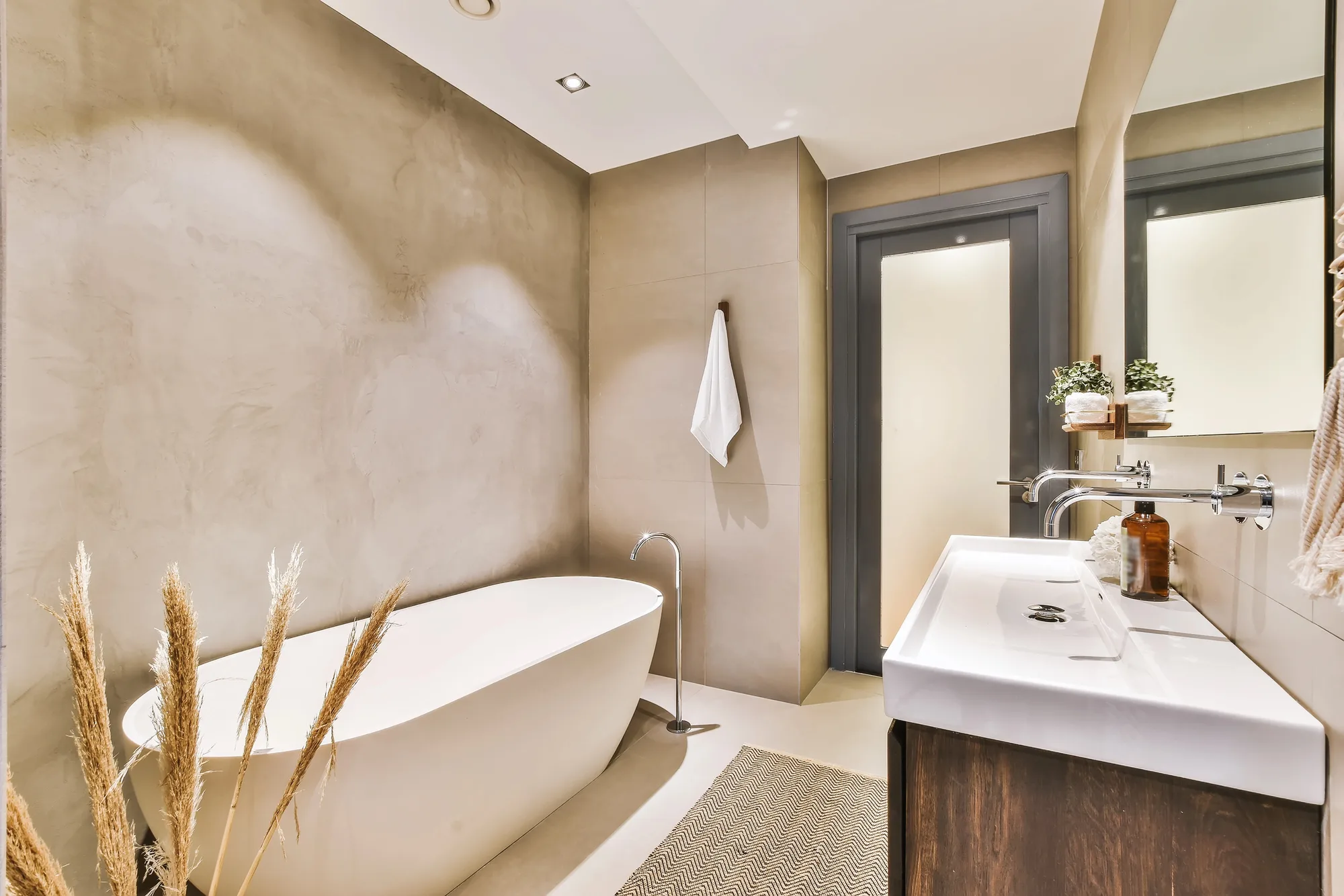 Fully renovated bathroom with freestanding bath, wall hung basin and rendered walls